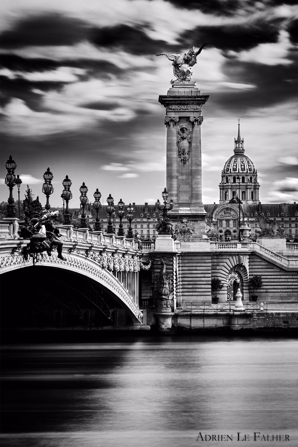 a black and white photo of a bridge over water
